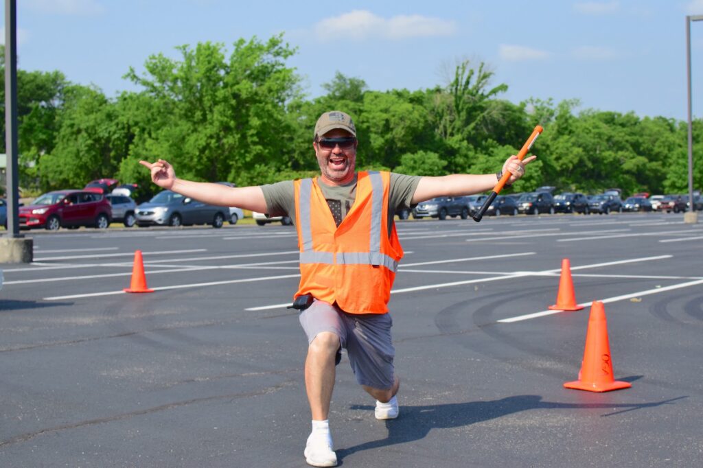 Scott Lucas strikes a pose in the parking lot at OneGenAway's mobile food pantry.