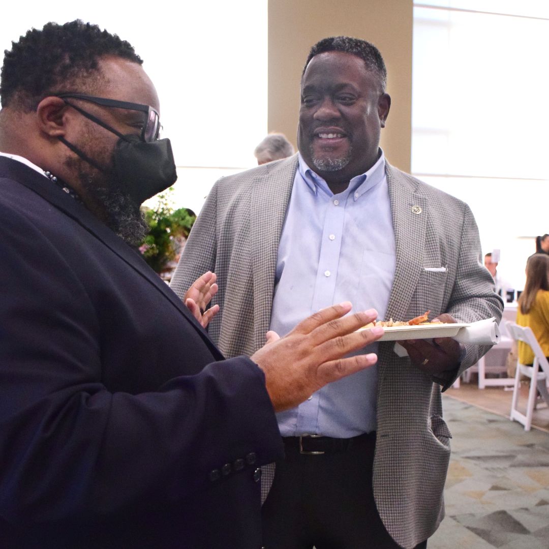 Walter Simmons and Kevin Townsel chat at the 2022 Million Meal Spring Breakfast