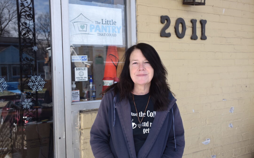 Stacy Downey stands in front of the door at The Little Pantry That Could
