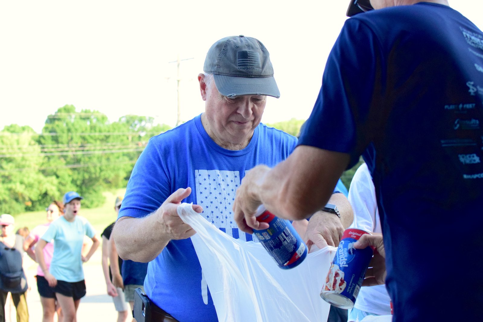 OneGenAway volunteer, Cookie Bob, helps sort food at OneGenAway's mobile food pantry.