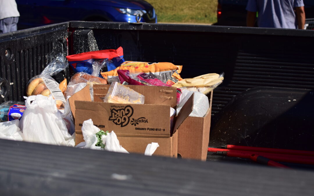 Boxes and bags of groceries sit in the bed of a pickup truck at the OneGenAway Mobile Pantry.
